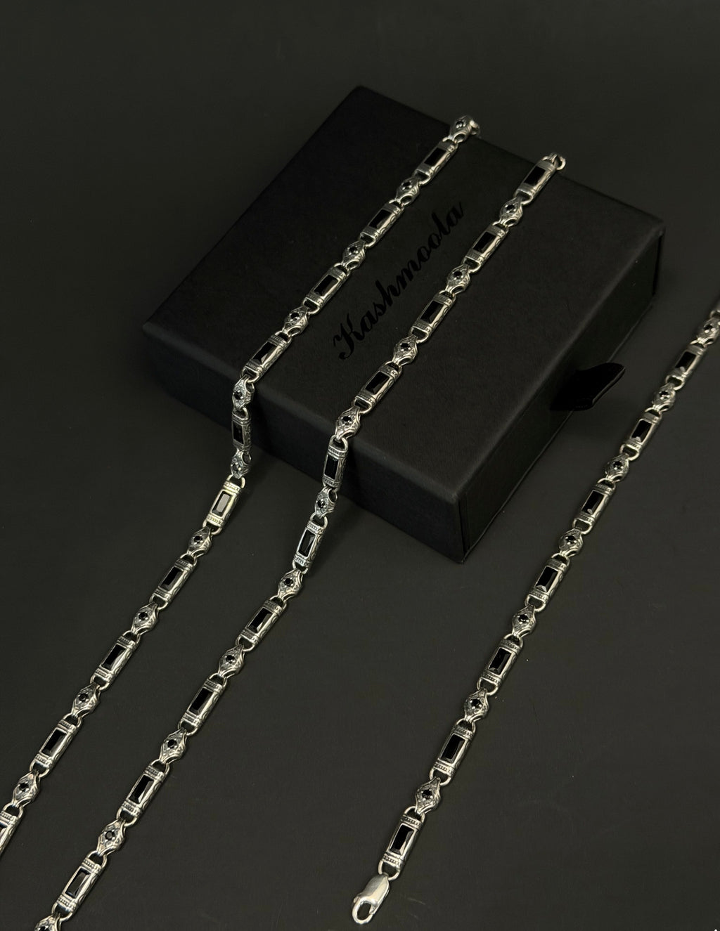 Genuine 925 sterling silver heritage-inspired jewelry featuring black rectangular accents and intricate decorative details. Available as a bracelet or necklace in multiple color options.